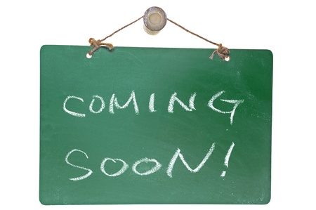 Coming soon words on green board isolated on white backgroundの写真素材