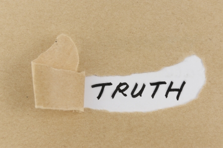 Teared paper with truth word behind itの写真素材
