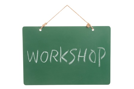 Workshop word on green board hanging by a  ropeの写真素材