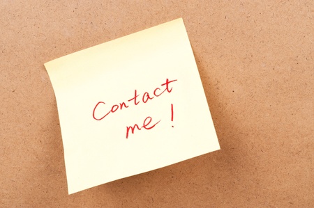 Contact me words written on a sticky noteの写真素材