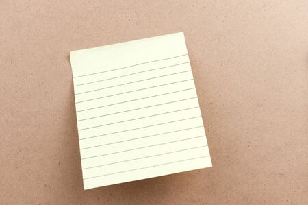 Blank sticky note attached on the wooden boardの写真素材
