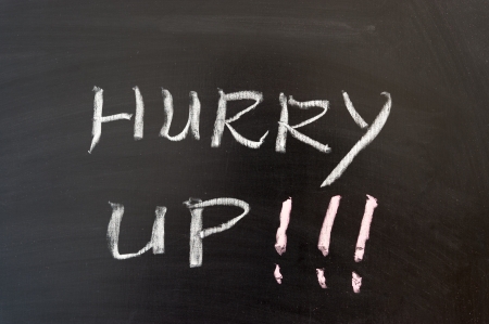Hurry up words written on the chalkboardの写真素材