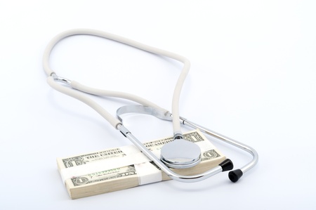 Stethoscope on a pile of paper moneyの写真素材