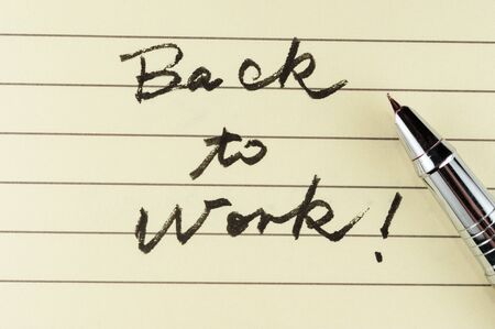 Back to work words written on lined paper with a pen on itの写真素材