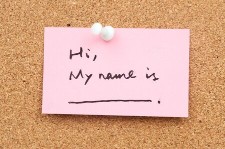 Note paper pinned on cork board which written "Hi, My name is"の写真素材