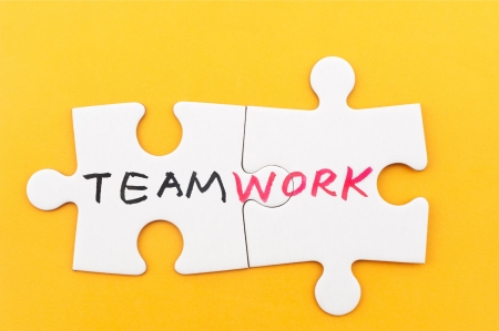 Teamwork word written on two pieces of white paper jigsaw puzzlesの写真素材