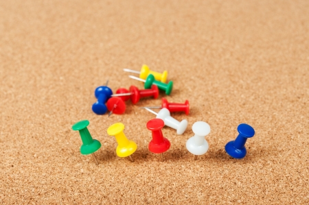 Group of thumbtacks pinned on cork boardの写真素材