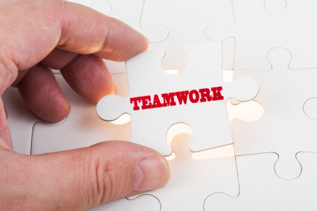 Teamwork concept word insert into group of jigsaw puzzlesの写真素材