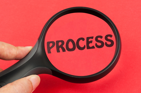 Process using a magnifier tool on handの写真素材