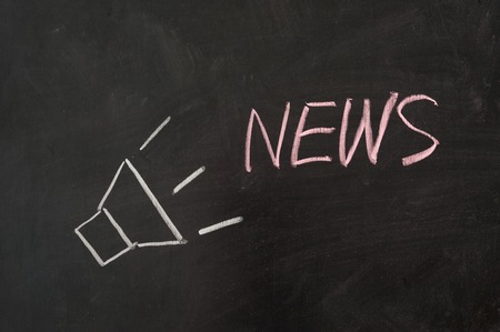 News word with loud speaker on blackboardの写真素材