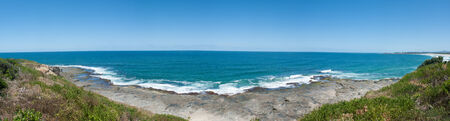 Australia ocean panorama landscape with wave slamming on the rocks of the coastlineの写真素材