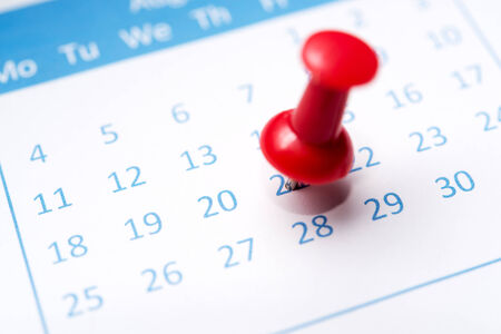 Close up of calendar pinned with thumbtack 