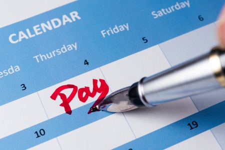 Pay word written on the calendar with a penの写真素材