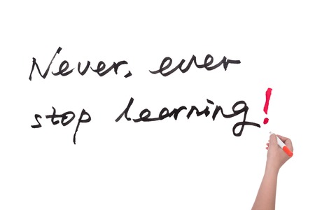 Never ever stop learning words written on white boardの写真素材