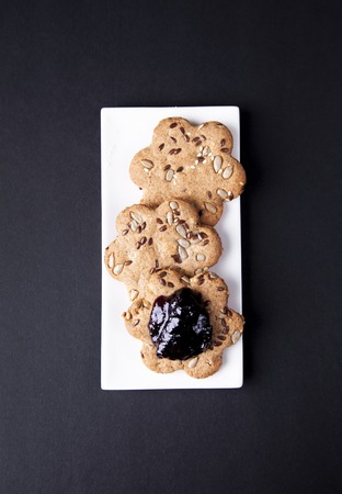 Biscuits in a white plate on a dark backgroundの写真素材