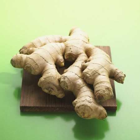 Ginger Root on Cutting Boardの写真素材