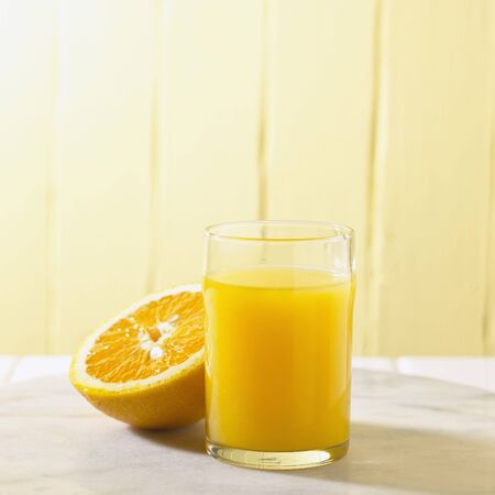 Orange Half and Glass of Juiceの写真素材