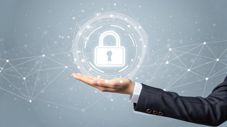 Businesswoman hand holding a virtual security padlock on a gray backgroundの素材