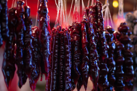 Traditional georgian sweet dessert churchkhella hanging at Christmas market in neon lightsの写真素材