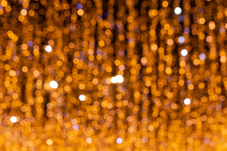 Blurred defocused golden bokeh abstract background. Christmas lights pattern