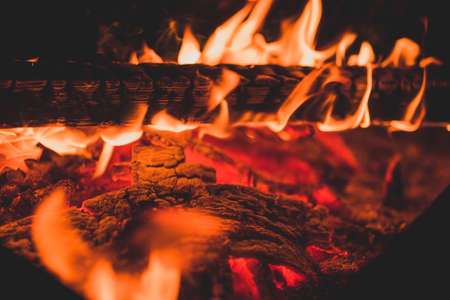 Close up of burning wooden log as abstract background. The hot embers of burning smoldering fire.の写真素材