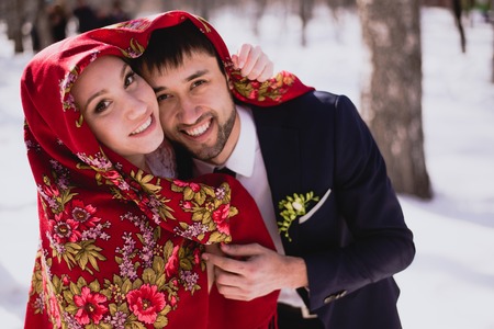 Happy bride and groom in winter day on their wedding.の写真素材