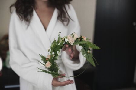 Bride holds her bridal wreath in the hands of.の写真素材