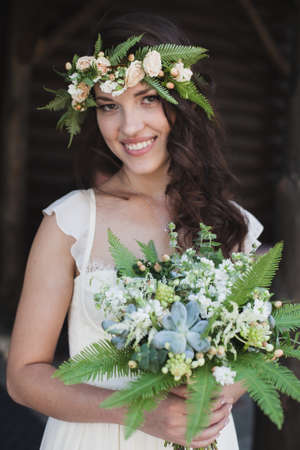 Portrait of beautiful bride with green flowers.の写真素材