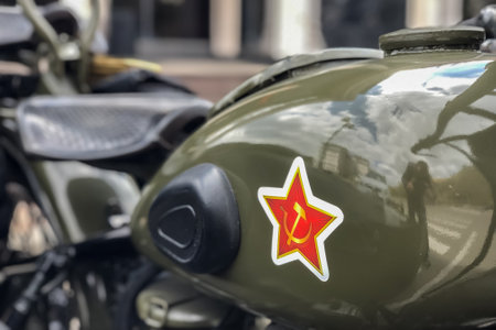 Soviet star and hammer and sickle on the gas tank of the Soviet motorcycle URAL, close-up.のeditorial素材