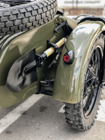 Soviet army sapper shovel of the second world war on Russian retro motorcycle URAL.