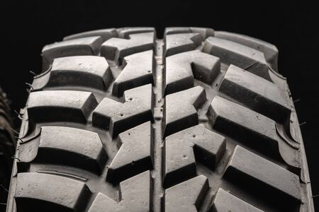 off-road tire protector from SUV class on a black background, close-up.