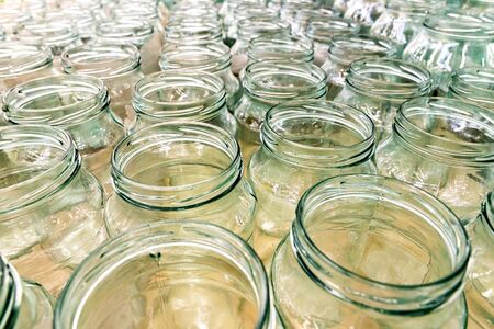 Lots of empty transparent jars in rows backgroundの写真素材