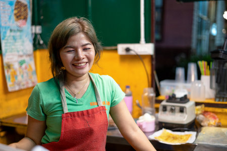 Khaolak, Thailand, 5 june 2019: ute Thai woman cooking and selling traditional Thai sweet pancakes Roti on the street of Khao Lak in Thailand.のeditorial素材