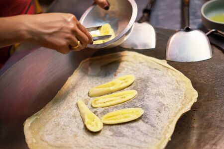 Thai woman cooking and selling traditional Thai sweet pancakes on the street of Khao Lak in Thailand.の写真素材