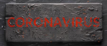 Coronavirus-the inscription in blood on a black plate. ominous bloody letters, long sign