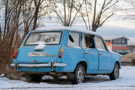 Krasnoyarsk, Russia, February 1, 2020: old abandoned retro car blue vaz 2102, licensed copy of fiat 124, parked in the winter and in the snowのeditorial素材