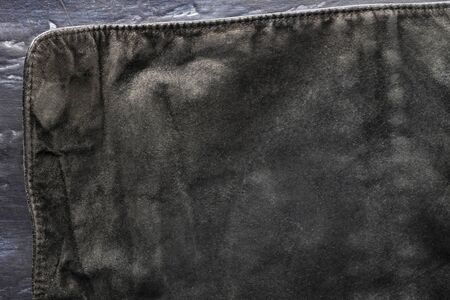 black structural background - old shabby stylish suede, reverse side, old fabric, textile. piece of...