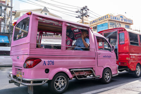 Patong, Phuket Thailand, January 5, 2020: pink tuk tuk is waiting for customers and tourists on the roadside, the taxi driver is Smokingのeditorial素材