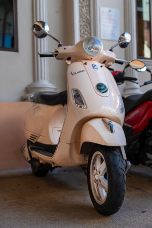 Patong, Phuket Thailand, January 5, 2020: retro-style beige MOTOBIKE stands in the Parking lot, vertical close-up photoのeditorial素材