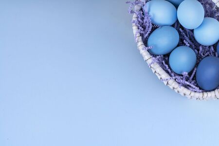 Easter eggs are blue and light blue in a beautiful basket. spring composition. flatlay.