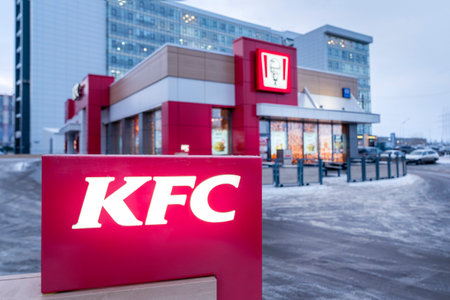 Krasnoyarsk, Russia, March 20, 2020: KFC restaurant, view of the building from the outside and a burning advertising sign. Winterのeditorial素材