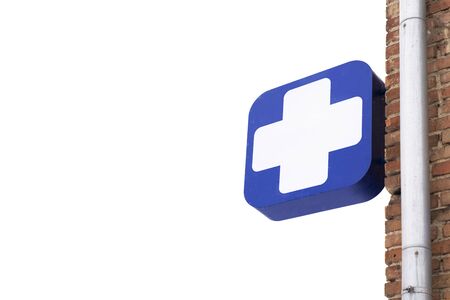 sign medical cross pharmacy on a white background. Isolate. sign on the facade of the buildingの写真素材