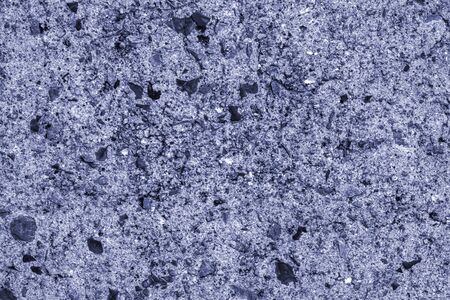 blue concrete wall interspersed with blue-tinged stone, scratches, structural backgroundの写真素材