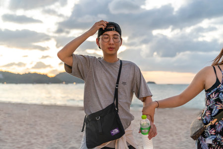 Thailand, Phuket, March 30, 2020: funny Chinese man with glasses, stupid look. he closed his eyes...