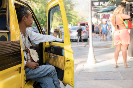 Thailand, Phuket, April 15, 2020: a male tuk tuk driver is waiting for customersのeditorial素材