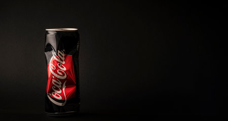 a crumpled Coca-Cola can on a black background, copy space, long layoutのeditorial素材