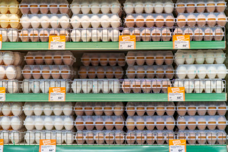 Krasnoyarsk, Russia, August 10, 2020: chicken eggs in cells on a shop window.のeditorial素材