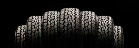 tires on a black background in a row, panoramic photo.の写真素材