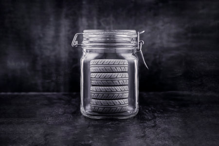 Set of new car tires in a glass jar