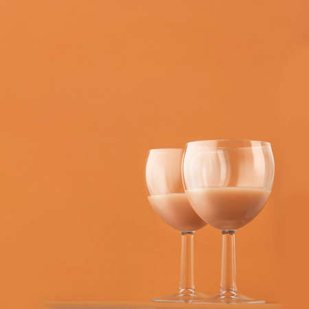 two glasses of cofftwo glasses of coffee liqueur on a brown background, square photo. Copy spaceee liqueur on a brown background, square photo. Copy space ..の写真素材
